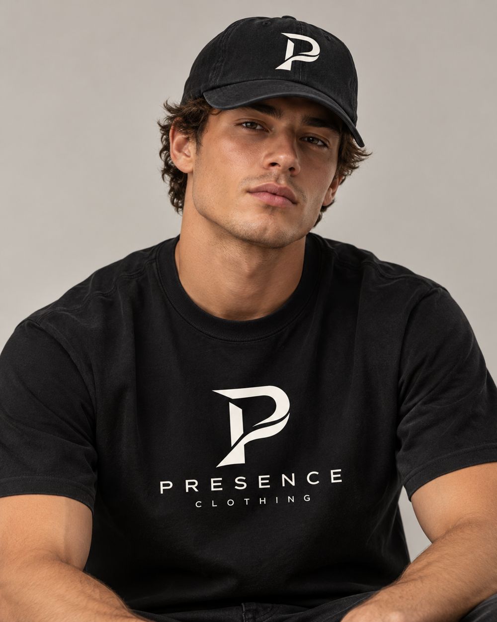 Man in the black Presence Tee and Dad Hat